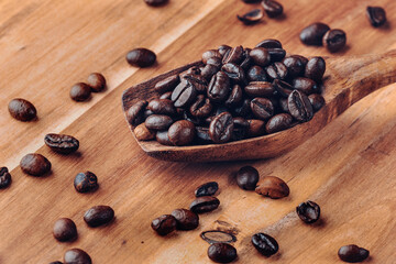 Closeup of coffee beans with wooden scoop