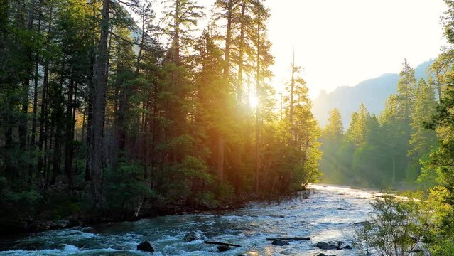Beautiful morning shot of the sun shining on the Merced River as it runs through Yosemite National Park in California.