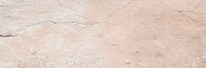 Concrete wall texture with cracked plaster. Weathered uneven rough surface. Perfect for background and grunge design.