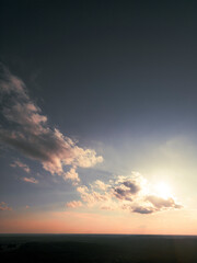 Fototapeta na wymiar Setting Sun in the Clouds over a Distant Georgia Landscape