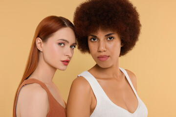 Portrait of beautiful young women on beige background