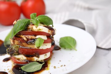 Stacked Caprese salad with balsamic vinegar on table, closeup. Space for text