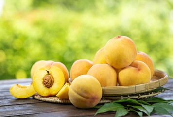 Yellow Peach fruit on wooden basket in garden background, Fresh Yellow Peach.