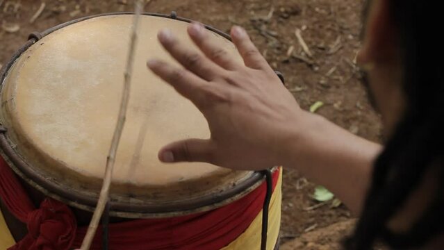 detail of hands playing timbal percussion instrument