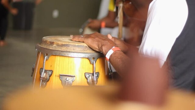 detail of hands playing timbal percussion instrument