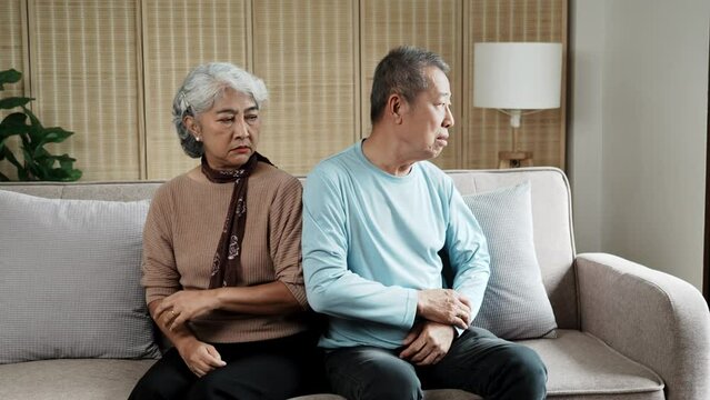 Senior Asain couple, fight and divorce in stress, conflict or argument from disagreement on living room sofa at home.