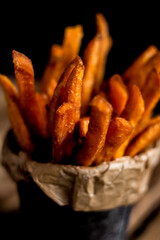 Close-up of sweet potato fries on a dark background