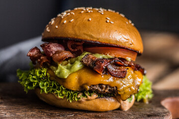 Close-up of cheeseburger with bacon and guacamole