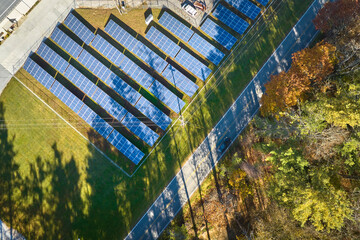 Aerial view of large sustainable electrical power plant with rows of solar photovoltaic panels for...