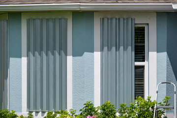 Hurricane shutters made from steel mounted for protection of house windows. Protective measures...