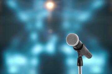 Microphone with stage light background for performance concept of speech comment and public speaking - obrazy, fototapety, plakaty