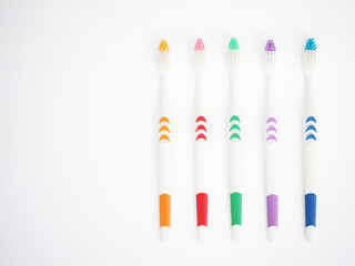 Set of colorful toothbrush on white background. Closeup photo, blurred.
