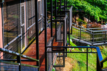 Fototapeta na wymiar Black metal stairs with wooden walkaway at the industrial architecture building in Malaysia.