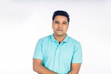 Confident indian man in t shirt standing on white background.