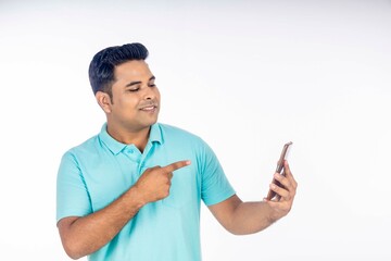 Indian man using smartphone on white background.