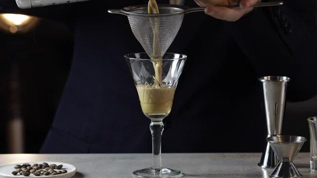 Bartender preparing Espresso Martini cocktail