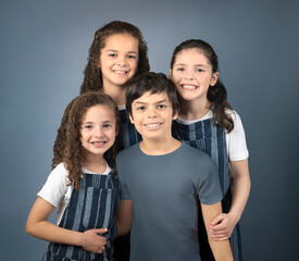 Family portrait three girls, one boy isolated on blue background - 631384315