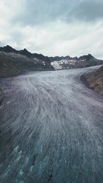 vertical video. glacier in switzerland Rhonegletscher, glacier tainier, top view, global warming