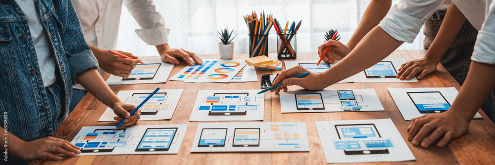 Poster Panorama shot of front-end developer team brainstorming UI and UX designs for mobile app on paper wireframe interface. User interface development team planning for user-friendly UI design. Scrutinize