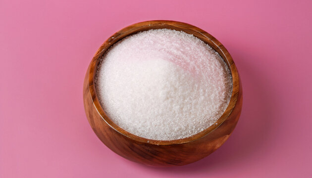 Natural sweetener in a wooden bowl on a pink background. Sugar substitute. Erythritol.