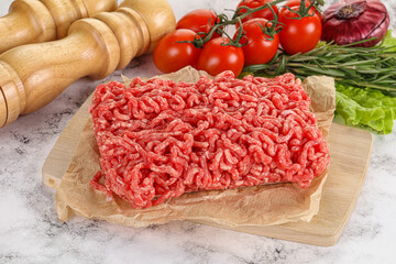 Raw minced beef meat on cutting board