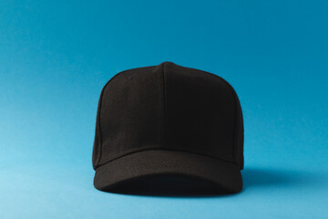 Black baseball cap and copy space on blue background