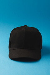 Black baseball cap and copy space on blue background
