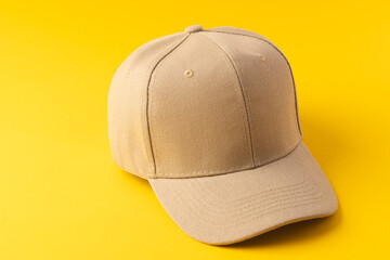 Cream baseball cap and copy space on yellow background