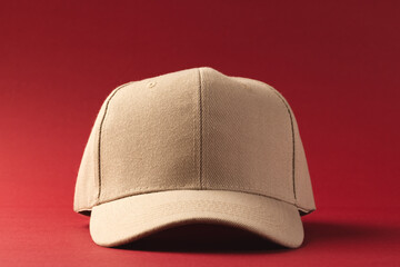 Cream baseball cap and copy space on red background