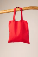  Red canvas bag hanging from wooden branch with copy space on white background © vectorfusionart