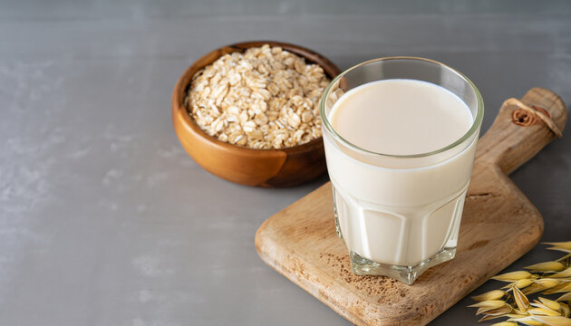 Vegan oat milk, non dairy alternative milk in a glass. Vegan non dairy alternative milk. Oat flakes milk. Copy space