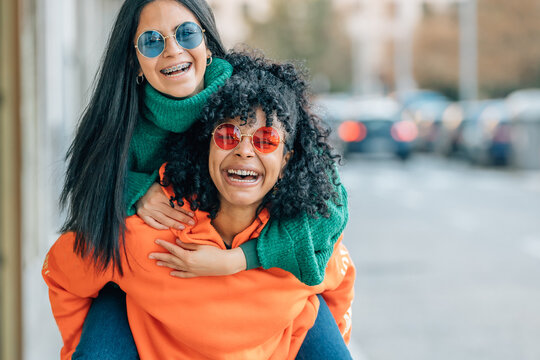 multiethnic girls having fun out loud on the street