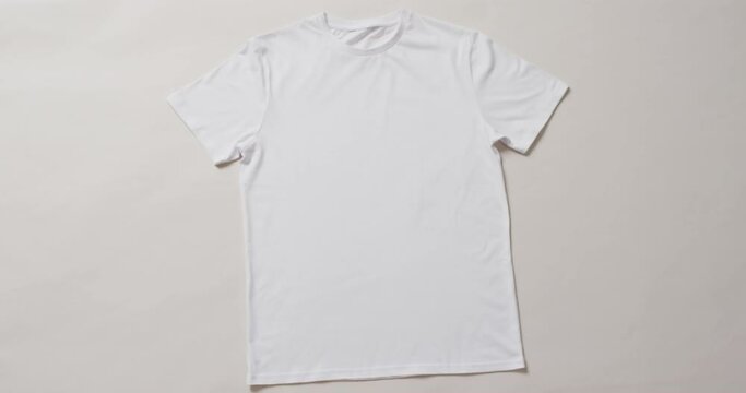 Video of flat lay of white t shirt with copy space on white background