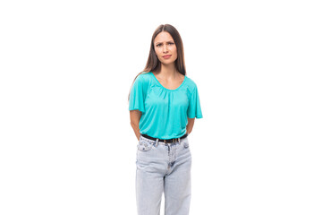 young attractive european woman with black long hair dressed in a blue t-shirt