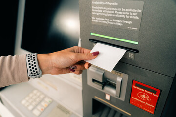 woman taking money from an ATM