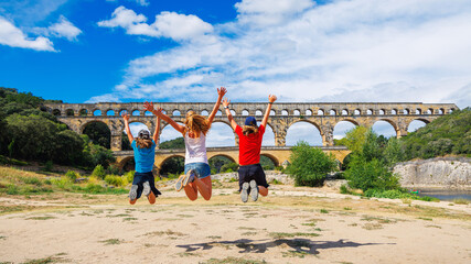 Happy family traveling in France- Pont du Gard- tour tourism, travel, vacation in the Gard