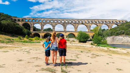 Happy family traveling in France- Pont du Gard- tour tourism, travel, vacation in the Gard