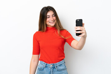 Young caucasian woman isolated on white background making a selfie