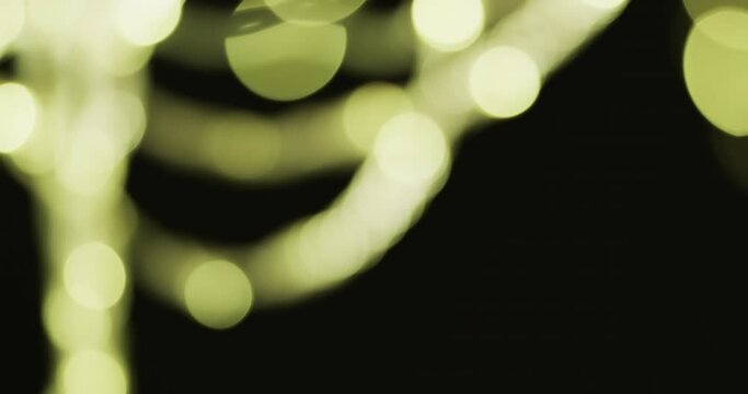 Video of flickering white and green bokeh spots of light with copy space