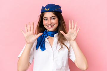 Airplane stewardess caucasian woman isolated on pink background counting ten with fingers