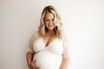 Naklejka premium Pregnant woman hugging her belly in studio on white background, AI generated