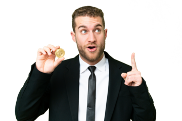 Young business blonde man holding a Bitcoin over isolated chroma key background thinking an idea pointing the finger up