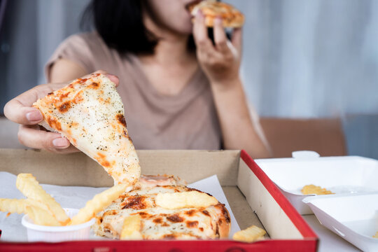 Binge eating disorder concept with woman overeating fast food pizza