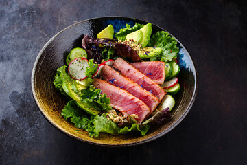 Traditionaler deutscher Blattsalat und serviert mit Thunfisch, Avocado und Gemüse als close-up in einer Nordic Design Schale mit Textfreiraum  