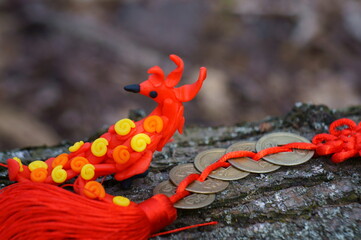 Phoenix bird made of plasticine and Chinese coins. A fictional fairy tale character.