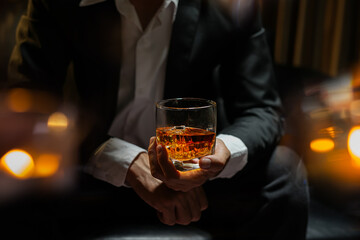 businessmen holding a glass of whiskey