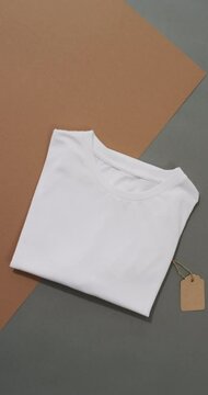 Vertical video of white t shirt and copy space on brown and grey background