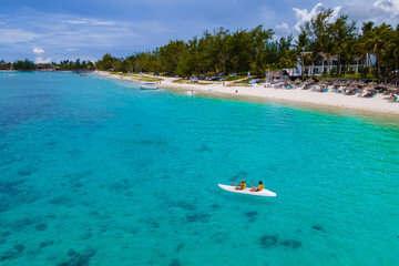 Mauritius vacation, couple man and woman in a kayak in a blue ocean in Mauritius. men and women...