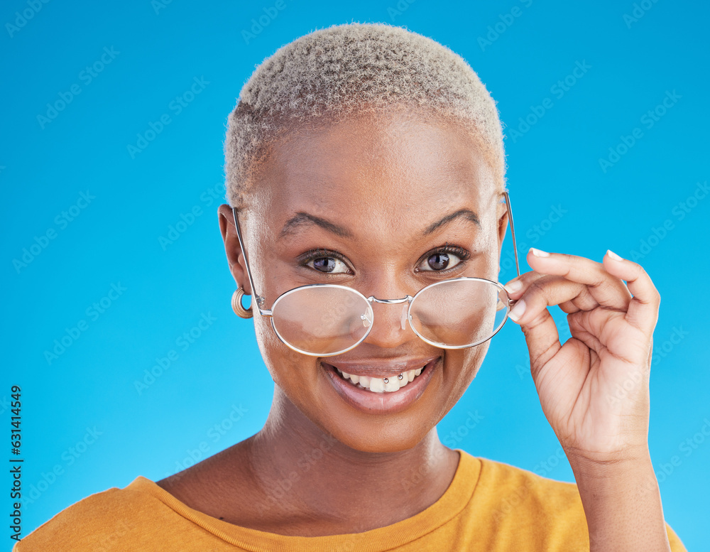 Wall mural Happy, portrait and black woman with glasses on a blue background for stylish, trendy and fashion. Cool, smile and headshot of an African girl or optometry model with eyewear for vision and eye care