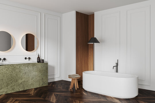 White bathroom interior with bathtub, double sink and minimalist decoration